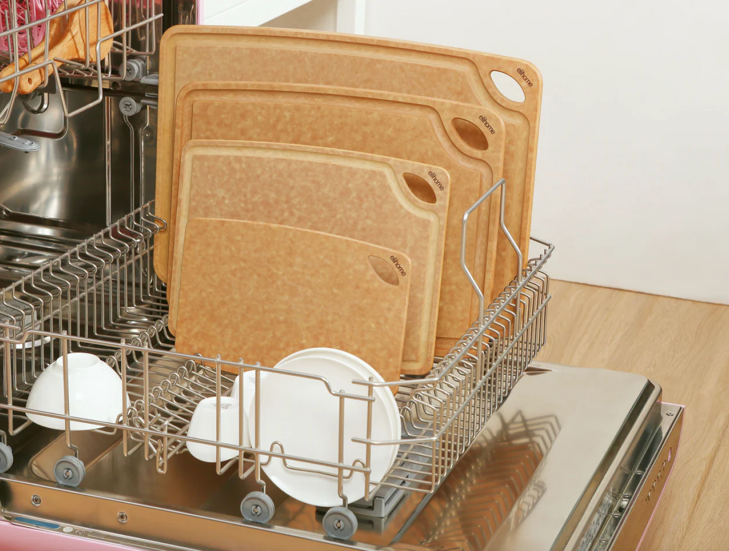 Set of wooden cutting boards in a dishwasher with a white background