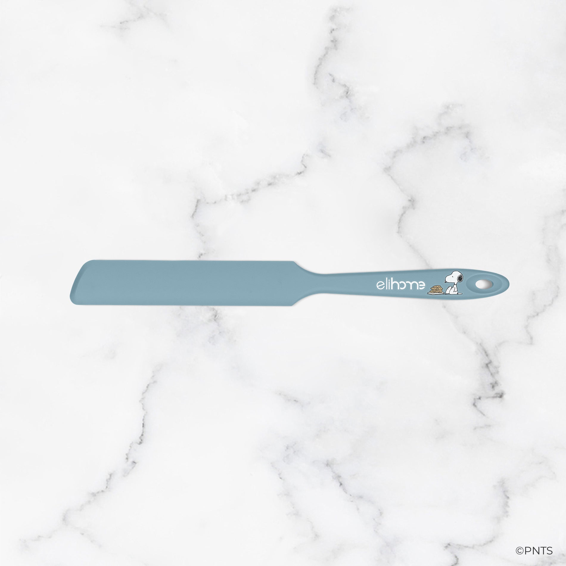 Blue spatula with 'elhome' branding on a marble background