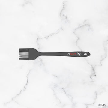 Black hairbrush with a brand logo on a marble background