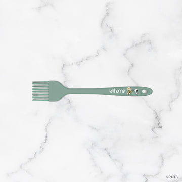 Green spatula with 'elihome' branding on a marble background