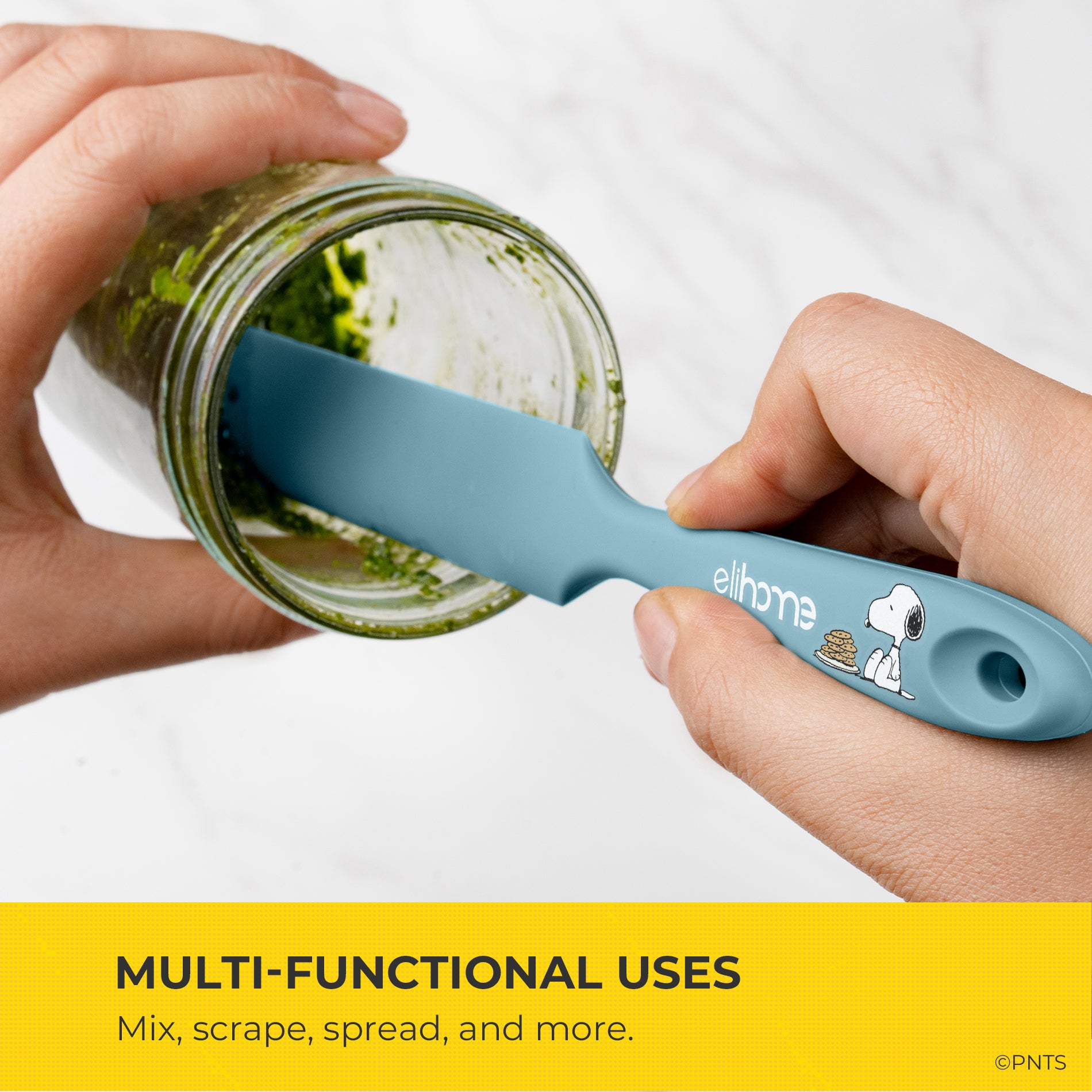 Blue spatula with a design on it being used to mix contents in a jar, with text about multi-functional uses.