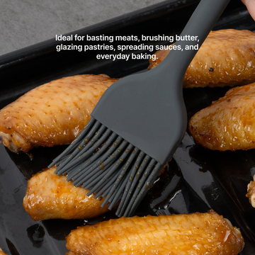 Elihome Mini Basting Pastry Brush in Dark Grey glazing baked chicken wings on a sheet pan, ideal for basting meats, brushing butter, glazing pastries, spreading sauces and everyday baking