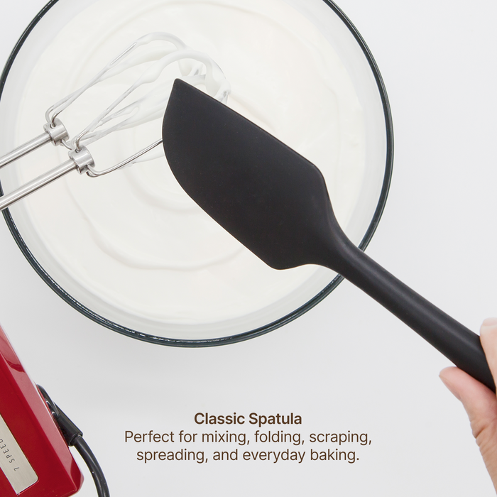 Elihome Classic Silicone Spatula from the silicone kitchen tool set in use, folding whipped cream in a mixing bowl