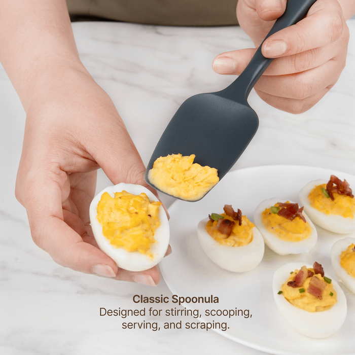 Elihome Classic Silicone Spoonula from the silicone kitchen tool set in use, scooping filling onto deviled eggs