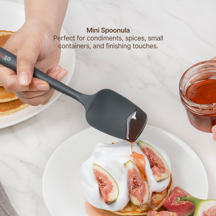 Elihome Mini Silicone Spoonula from the silicone kitchen tool set in use, spooning honey over figs and cream