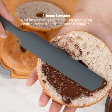 Elihome Premium Silicone Spreader from the silicone kitchen tool set in use, spreading chocolate on a bagel half